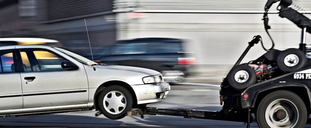 A car being towed by a tow truck.